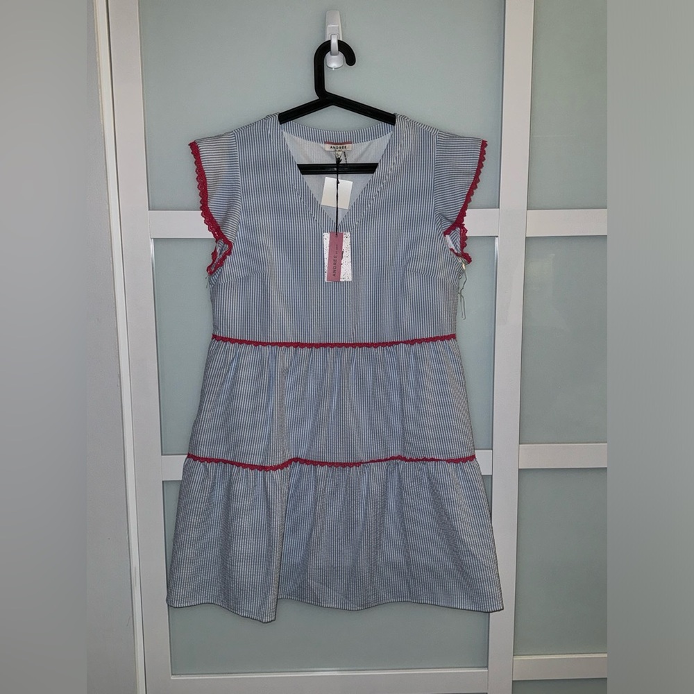 Cute summer dress by Andre.  Blue and white stripes with cute pink detail.